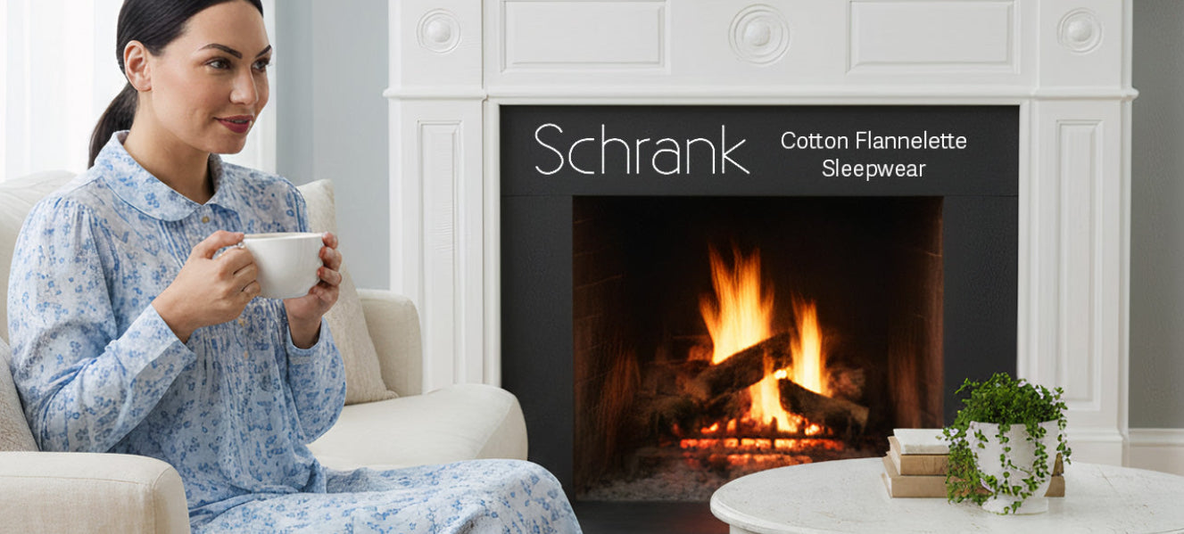 Woman wearing schrank flannelette nightgown holding a mug in front of a fireplace.
